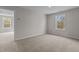 Bright, empty bedroom with a neutral color palette and carpet, lit by two large windows at 9184 Phoenix Ct, Middlesex, NC 27557