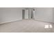 Clean and empty bedroom with a neutral carpet, a large window and white trim at 9184 Phoenix Ct, Middlesex, NC 27557