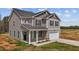 Two-story home features a covered porch with white columns and a two-car garage with a long concrete driveway at 9184 Phoenix Ct, Middlesex, NC 27557