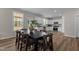 Open-concept kitchen and dining area with stainless steel appliances and wood flooring, great for entertaining at 9184 Phoenix Ct, Middlesex, NC 27557
