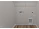 A laundry room with new vinyl flooring and sleek hookups at 9184 Phoenix Ct, Middlesex, NC 27557