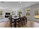Open-concept living and dining areas with wood floors and large windows, seamlessly connecting the spaces at 9184 Phoenix Ct, Middlesex, NC 27557