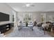 Spacious living room with a ceiling fan, sofa, armchairs, and a large decorative rug with wood-look flooring at 9184 Phoenix Ct, Middlesex, NC 27557