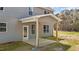 Covered back patio with wooden support beams and new gray siding at 9184 Phoenix Ct, Middlesex, NC 27557