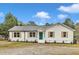 Charming single-story home with a well-maintained lawn and inviting entryway at 8201 Rhodes Rd, Apex, NC 27539