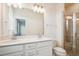Bathroom featuring double sink vanity, shower with glass door, and neutral fixtures at 853 Parc Townes Dr # 9, Wendell, NC 27591