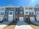 Row of new townhomes showing multiple colors and stone accents, along with individual driveways and garages at 853 Parc Townes Dr # 9, Wendell, NC 27591