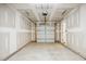 Spacious unfinished garage with a clean concrete floor and a closed garage door at 853 Parc Townes Dr # 9, Wendell, NC 27591