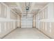 Spacious unfinished garage with a clean concrete floor and a closed garage door at 853 Parc Townes Dr # 9, Wendell, NC 27591