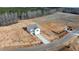 Aerial view of new construction home with long driveway on large lot and future new home in the background at 9154 Phoenix Ct, Spring Hope, NC 27882