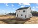 Backyard features a freshly seeded yard with the rear of the white house at 9154 Phoenix Ct, Middlesex, NC 27557