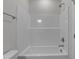 Bright bathroom features a white tub, shower combo, and chrome fixtures at 9154 Phoenix Ct, Middlesex, NC 27557