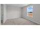 Neutral bedroom showcases natural light from window and plush carpet at 9154 Phoenix Ct, Middlesex, NC 27557
