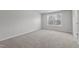 Cozy bedroom featuring neutral carpeting and a large window providing plenty of natural light at 9154 Phoenix Ct, Middlesex, NC 27557