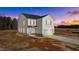 Two-story home with vinyl siding, attached garage, and new landscaping under a colorful sunset at 9154 Phoenix Ct, Middlesex, NC 27557