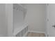 Mudroom features a bench with cubbies, coat hooks and neutral color palette at 9154 Phoenix Ct, Middlesex, NC 27557