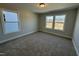 Cozy bedroom with carpeted floors and views from multiple large windows at 1009 Bostonian Dr, Knightdale, NC 27545