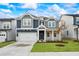 Two-story home boasting a large front yard, an attached garage and beautiful blue and gray siding at 1009 Bostonian Dr, Knightdale, NC 27545