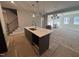 Modern kitchen with dark cabinets, white quartz island, and stainless steel appliances at 1009 Bostonian Dr, Knightdale, NC 27545