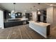 Modern kitchen with dark cabinets, white quartz island, and stainless steel appliances at 1009 Bostonian Dr, Knightdale, NC 27545