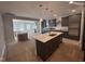 Modern kitchen with dark cabinets, white quartz island, and stainless steel appliances at 1009 Bostonian Dr, Knightdale, NC 27545