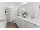 Bright bathroom featuring double sinks, white cabinetry and a shower/tub at 10529 Pleasant Branch Dr # 201, Raleigh, NC 27614