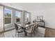 A dining room featuring a modern table set with seating for eight and decorative lighting at 10529 Pleasant Branch Dr # 201, Raleigh, NC 27614