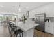 Bright kitchen with stainless steel appliances, large island with seating, and modern pendant lighting at 10529 Pleasant Branch Dr # 201, Raleigh, NC 27614