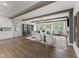 Spacious living room with wood-look floors, neutral furniture, large windows, and a view to the backyard at 10529 Pleasant Branch Dr # 201, Raleigh, NC 27614