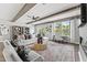 Stylish living room with neutral furniture, exposed beams, large windows, and an adjacent home office space at 10529 Pleasant Branch Dr # 201, Raleigh, NC 27614