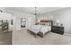 Spacious bedroom with modern chandelier, neutral decor, and ample natural light at 10529 Pleasant Branch Dr # 201, Raleigh, NC 27614