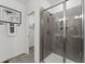 Modern bathroom with glass enclosed shower, neutral tile, and decorative black and white art at 10531 Pleasant Branch Dr # 101, Raleigh, NC 27614