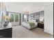 Bright main bedroom with neutral carpet, contemporary lighting, accent wall, and modern decor at 10531 Pleasant Branch Dr # 101, Raleigh, NC 27614