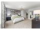 Bright main bedroom with neutral carpet, contemporary lighting, accent wall, and modern decor at 10531 Pleasant Branch Dr # 101, Raleigh, NC 27614