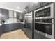 Modern kitchen with gray cabinetry, stainless steel appliances, and sleek countertops and backsplash at 10531 Pleasant Branch Dr # 101, Raleigh, NC 27614