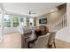 Open living space with dining area featuring a dark wood table and access to a well-lit living room at 10531 Pleasant Branch Dr # 101, Raleigh, NC 27614