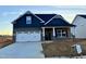 Charming new construction home with a white garage door and dark blue siding, providing a modern look at 1064 Fairhaven Dr # 95, Mebane, NC 27302