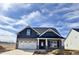Charming new construction home featuring a grey brick and siding exterior with a two-car garage at 1064 Fairhaven Dr # 95, Mebane, NC 27302