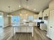 Open kitchen with a center island, stainless steel appliances, ample lighting, and an open floor plan at 1064 Fairhaven Dr # 95, Mebane, NC 27302