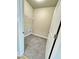 Inside view of a tiled laundry room with overhead rack and white trim at 1064 Fairhaven Dr # 95, Mebane, NC 27302
