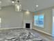 Bright living room with granite kitchen island and cozy fireplace feature at 1064 Fairhaven Dr # 95, Mebane, NC 27302