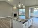 Open concept living room with granite island kitchen and inviting fireplace at 1064 Fairhaven Dr # 95, Mebane, NC 27302