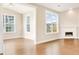 Bright living room featuring large windows, hardwood floors, and a cozy fireplace at 1064 Fairhaven Dr # 95, Mebane, NC 27302