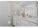 Bright bathroom featuring a double vanity with stone countertop and a large mirror at 132 Prairie Dog Dr, Louisburg, NC 27549
