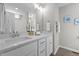 Bathroom showcasing a double vanity with undermount sinks, quartz counters, and chrome fixtures at 132 Prairie Dog Dr, Louisburg, NC 27549