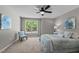 Cozy bedroom with natural light, carpet flooring, and a comfortable bed with decorative pillows at 132 Prairie Dog Dr, Louisburg, NC 27549