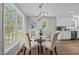 Bright dining room with a modern chandelier and large windows at 132 Prairie Dog Dr, Louisburg, NC 27549