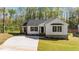 The home's charming exterior is complete with dark shutters and a well manicured lawn at 132 Prairie Dog Dr, Louisburg, NC 27549