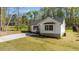 Side view of white house with manicured lawn on a sunny day at 132 Prairie Dog Dr, Louisburg, NC 27549