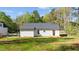 Exterior view of the home, featuring a white exterior, dark roof, and a grassy yard at 132 Prairie Dog Dr, Louisburg, NC 27549